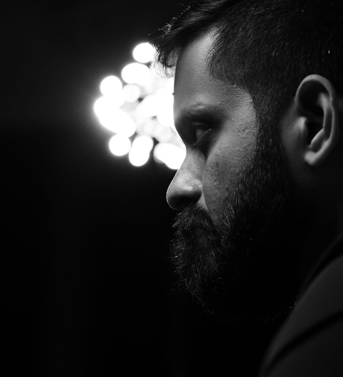 A cluster of lights beside him in the dark.