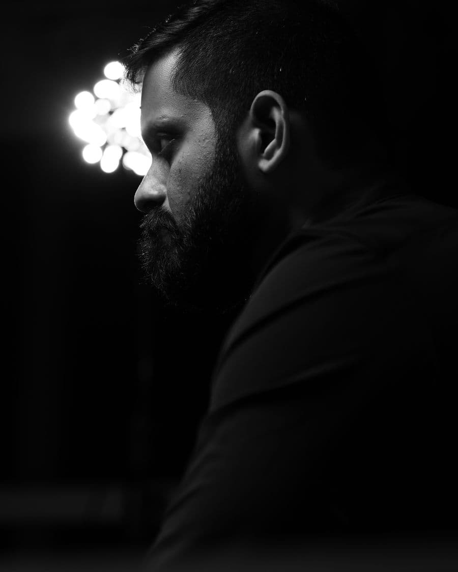 Shashank in profile, looking down and away from the camera.