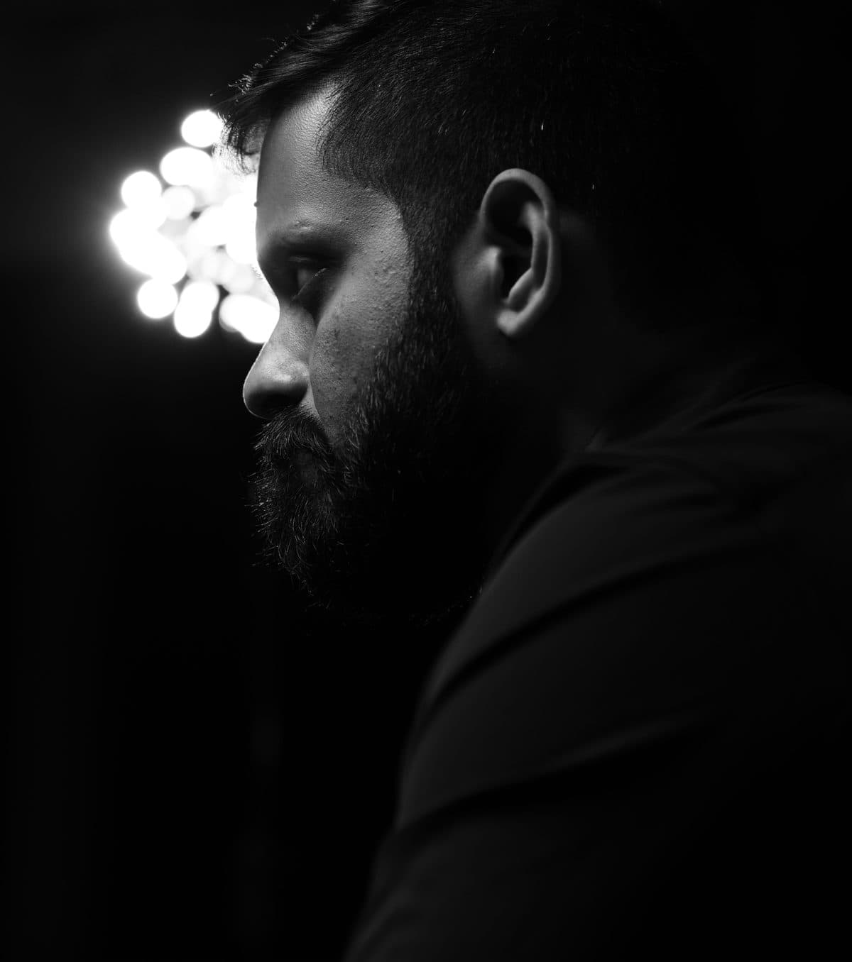 Shashank in profile, looking down and away.
