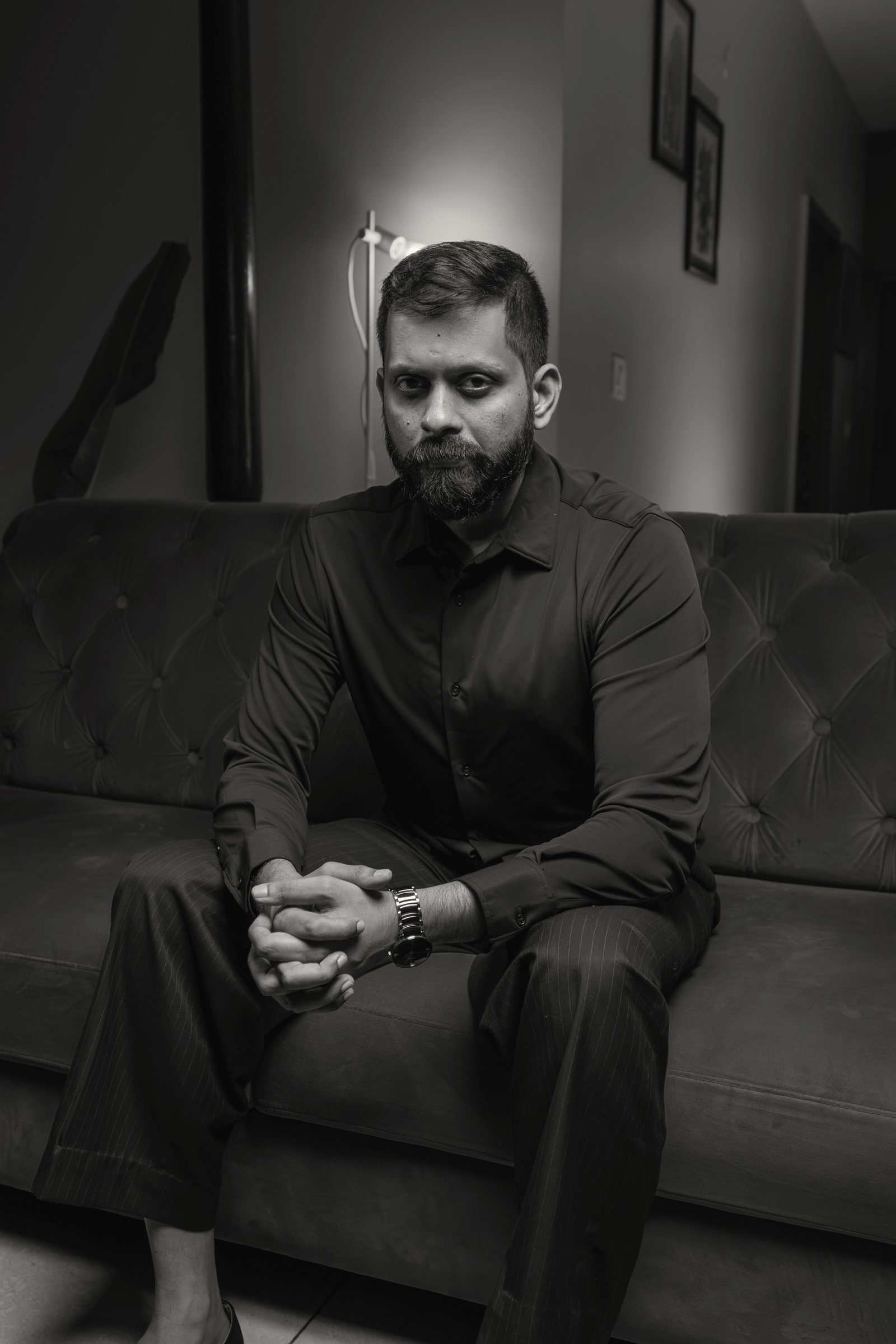 Shashank, seated, hands clasped.