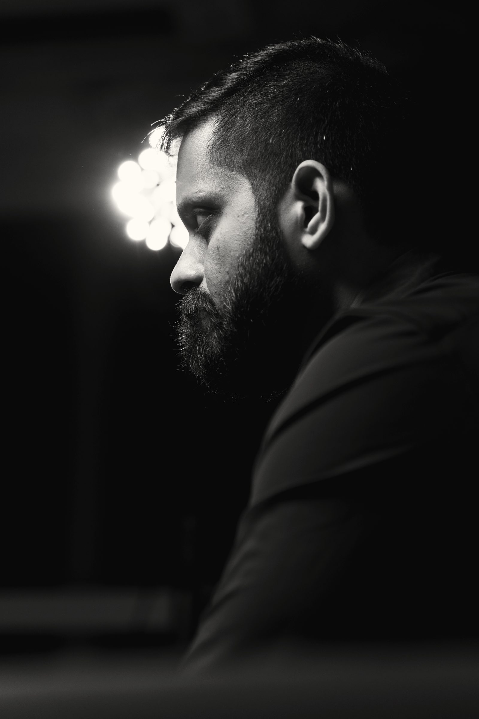 Shashank in shadow, half his face lit.