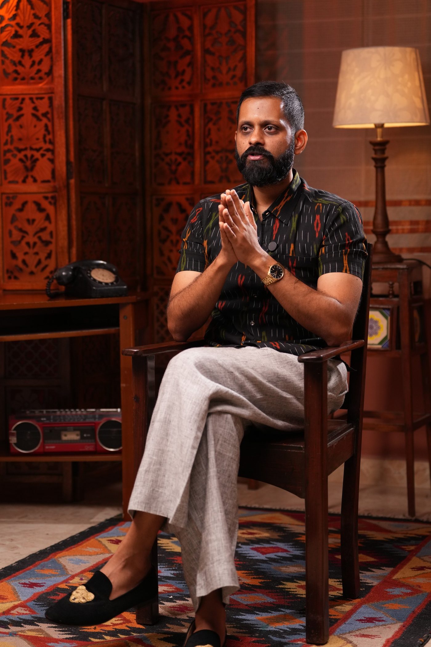Shashank, seated, hands together.