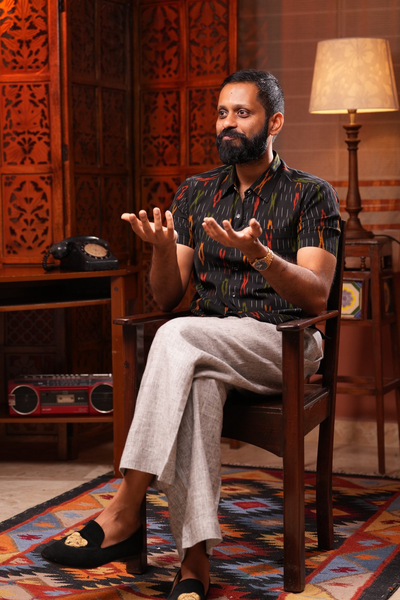 Shashank, seated, mid-conversation.