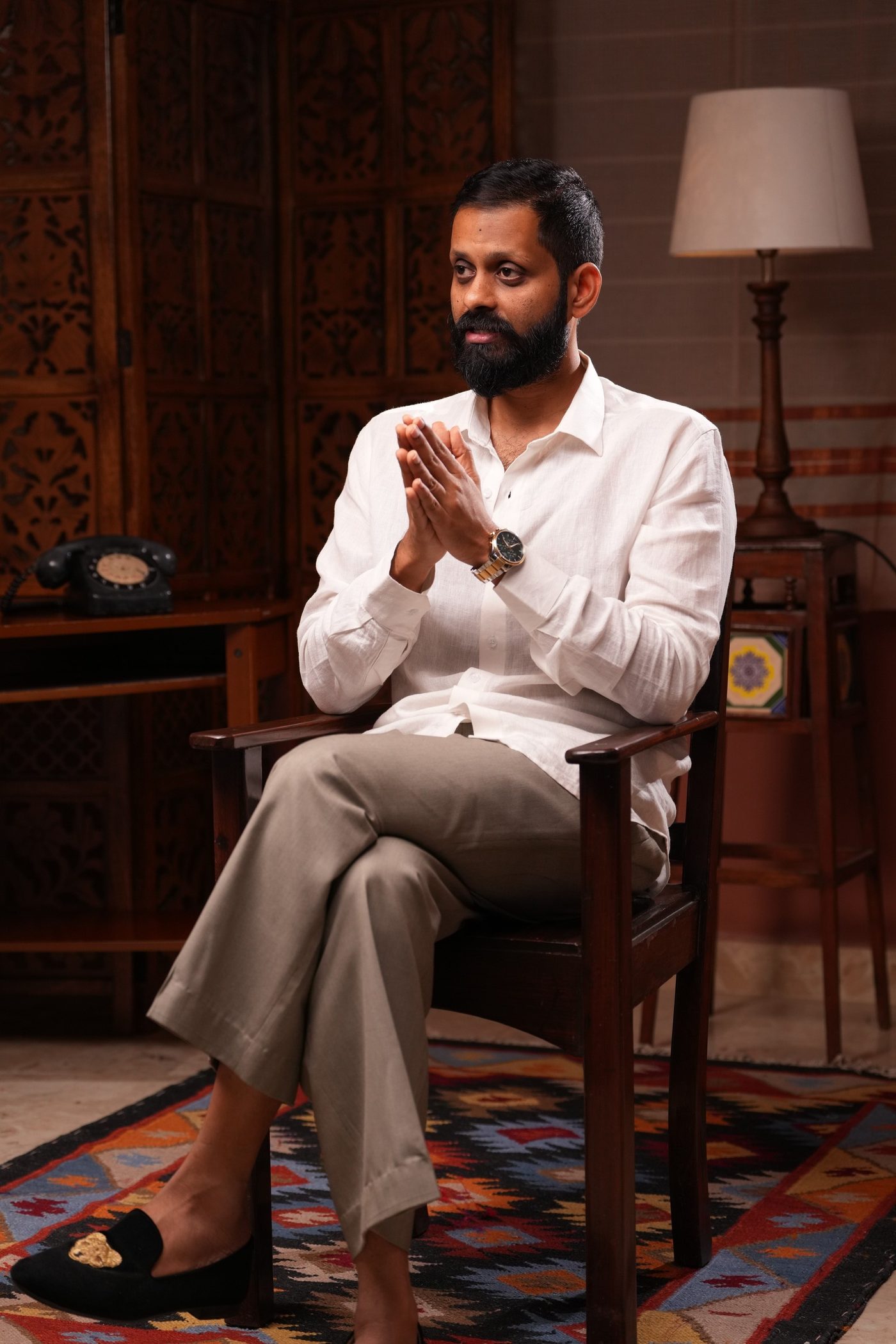 Shashank, seated, mid-conversation.